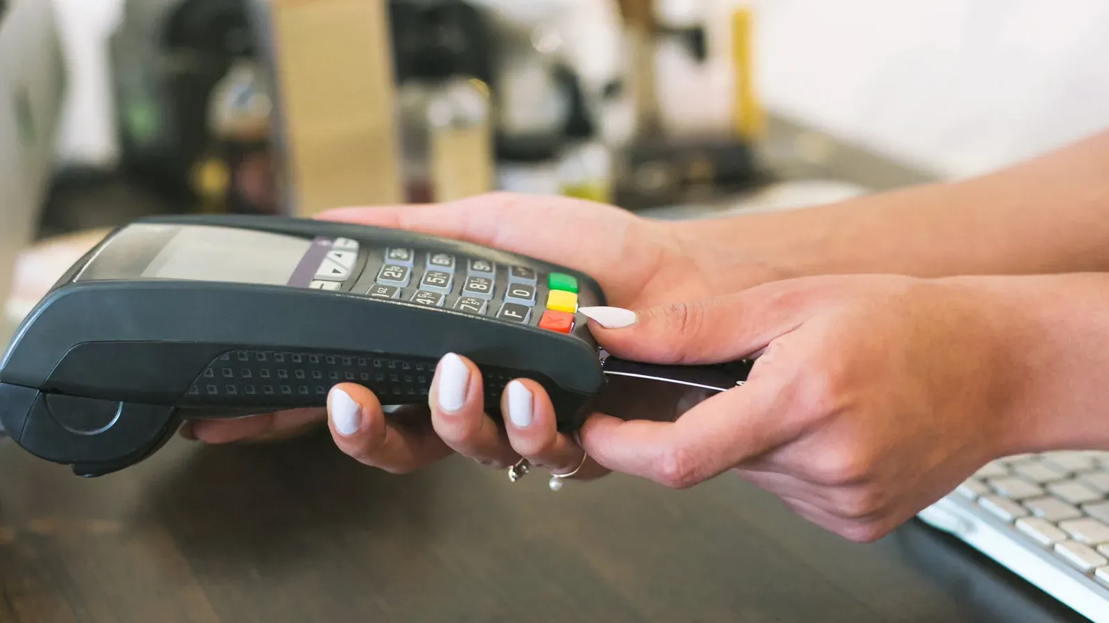 A card payment at a shop counter on a terminal.