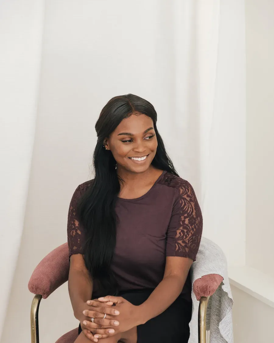 A business owner sits calmly in a bright room.